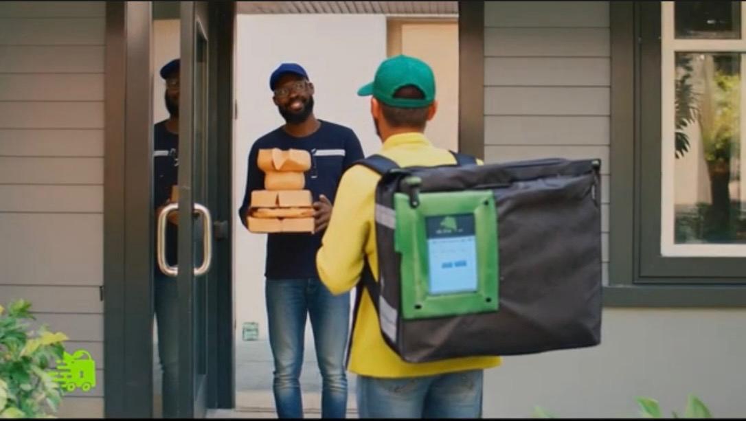 Courier delivering locked order at door
